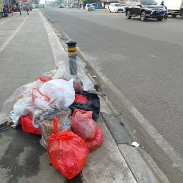 Garbage piled up on the side of the road Stock Photos