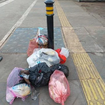 Garbage piled up on the side of the road Stock Photos