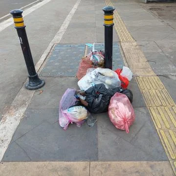Garbage piled up on the side of the road Stock Photos