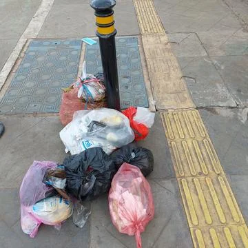 Garbage piled up on the side of the road Stock Photos