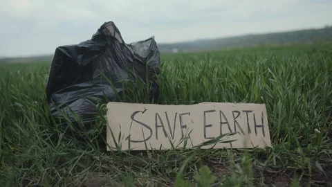 Garbage in a plastic bag plastic bottles lie on the grass on the nature poster Stock Footage 111824825