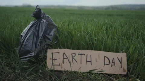 Garbage in a plastic bag plastic bottles lie on the grass on the nature poster Stock Footage 111824995