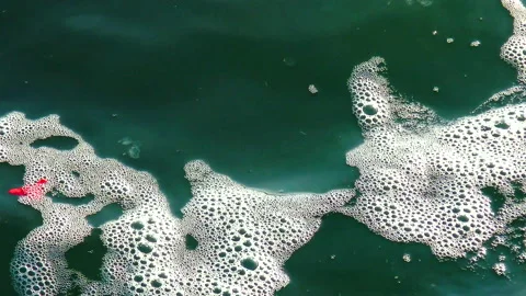 Garbage plastic bag on the sea beats with a wave, ecology Stock Footage 229893779