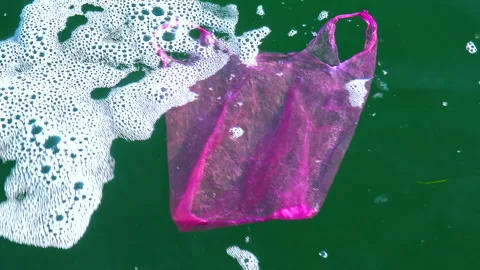 Garbage plastic bag on the sea beats with a wave, ecology Stock Footage 229894059