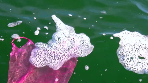 Garbage plastic bag on the sea beats with a wave, ecology Stock Footage 229894061