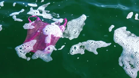 Garbage plastic bag on the sea beats with a wave, ecology Stock Footage 229894120