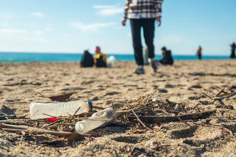 Garbage pollution of the planet. Empty plastic bottle on the beach sand Stock Photos