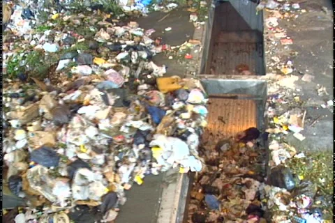GARBAGE PUSHED INTO TRUCKS Stock Footage 1052801