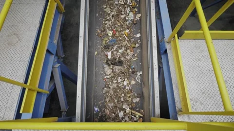 Garbage recycling factory, man worker sorts trash on conveyor belt at waste Stock Footage 251816971