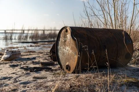 Garbage on the river. Dump. Environmental disaster. Iron in the ground. 스톡 사진