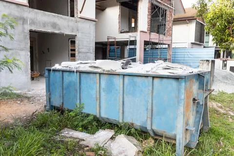 Garbage roro dumpter bin collects rubbish at construction site Stock Photos