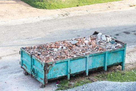 Garbage roro dumpter bin collects rubbish at construction site Stock Photos