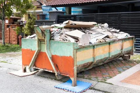 Garbage roro dumpter bin collects rubbish at construction site Stock Photos