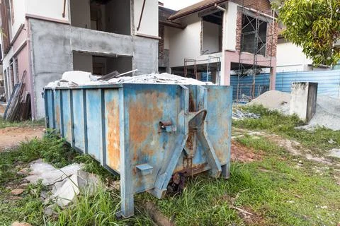 Garbage roro dumpter bin collects rubbish at construction site Stock Photos