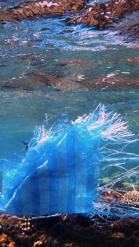 Garbage in the sea. Plastic pollution of the sea. used blue plastic bag slowly Stock Footage 307099823