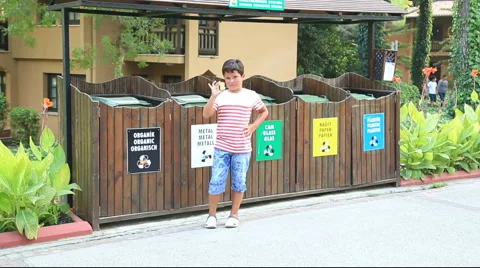 Garbage separation. Child throwing apple into the trash Stock Footage 66341350