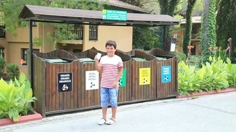 Garbage separation. Child throwing paper cup into the trash Stock Footage 66345211