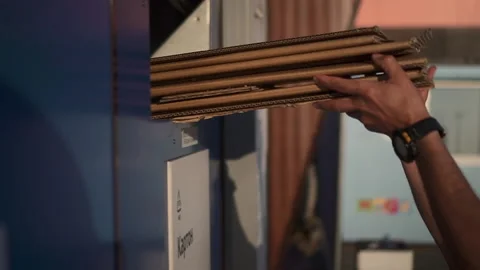 Garbage separation of man throws paper trash into compartment and stand outdoors Stock Footage 142924104