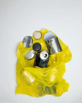 Garbage sorting, metal, yellow garbage bag with metal garbage Stock Photos