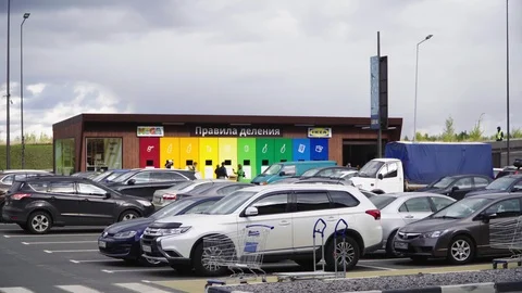 Garbage sorting station with bright cans near parking lot Stock Footage 125042553