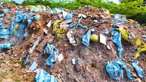 Garbage Stuck in the Sand Pile | Stock Video | Pond5