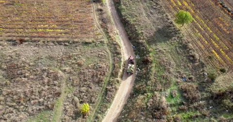 Garbage transportation by tractor pulling a trailer on rural road. Landfill d Stock Footage 276439998
