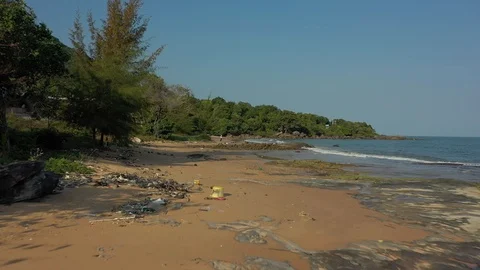 Garbage trash on a beach polluted shore ocean water dirty climate action needed Stock Footage 124326861