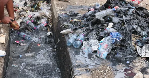 Garbage Trash sewer ditch drain poverty area Accra Ghana 4K Stock Footage 164339816