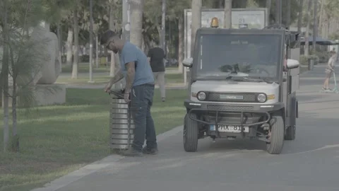A garbage truck and a worker on the beach in Paphos, Cyprus Stock-Footage 344056597