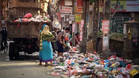 Garbage Truck Drops Trash and Rubbish on Thamel Street Stock Footage 94704672