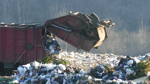 A garbage truck dumping waste onto a massive landfill site. Stock-Footage 321393195