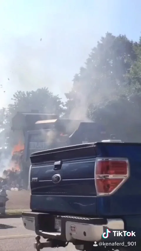 Garbage Truck Dumps Burning Load into Fire Station Parking Lot, Memphis, Tenness Stock Footage 205332815