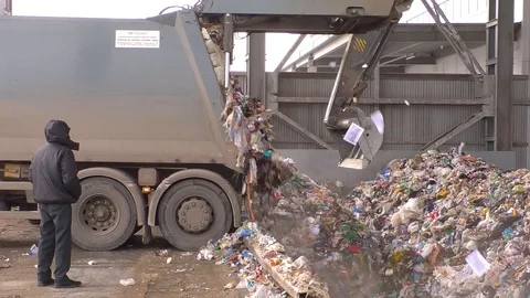 Garbage truck dumps garbage in a dump in the hangar Stock Footage 124707206