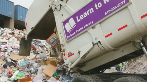 GARBAGE TRUCK DUMPS RECYCLABLES Stock Footage