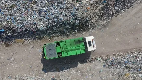 The garbage truck goes between the top of the garbage, aerial view Stock Footage 85290880