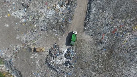 The garbage truck goes between the top of the garbage, aerial view Stock Footage 85290942