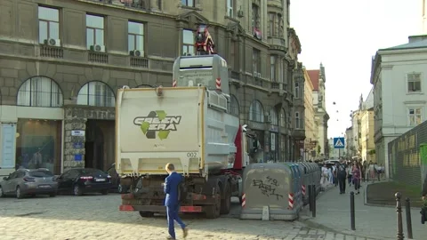 Garbage truck picks up the container and pours waste into the car body. Stock Footage 132252255
