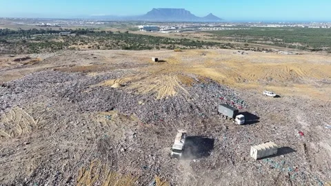 Garbage truck pulling into position to dump solid waste Stock Footage 296482419