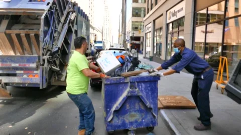 Garbage Trucks and Crews Working in Manhattan Video stock 130966031