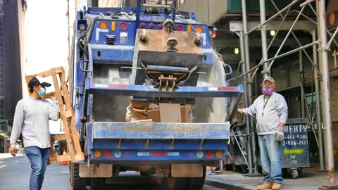 Garbage Trucks and Crews Working in Manhattan Stock-Footage 130966101