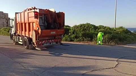 Garbage trucks with garbage collectors do door-to-door Stock Footage 141129654