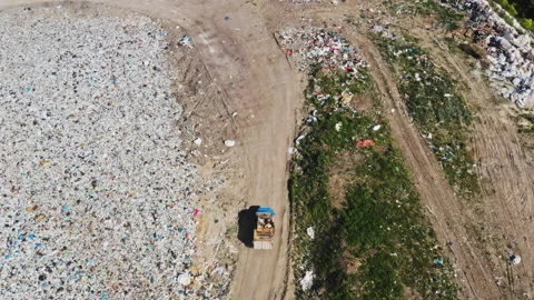 Garbage trucks unload garbage in a city landfill Stock-Footage 131841936