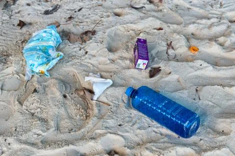 Garbage washed up on sand of beach 스톡 사진
