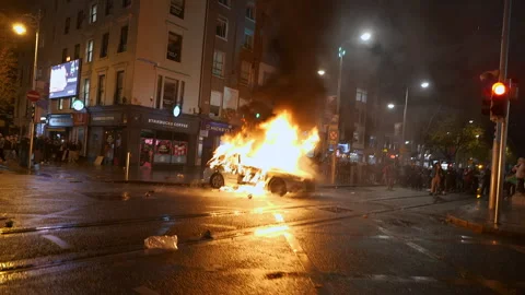 Garda police car explodes during violence in Dublin, Ireland - DUBLIN RIOTS 2023 Stock Footage 346228435