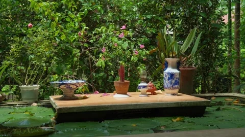 Garden altar table beside a lily pond in Hue, Vietnam, 4K Stock Footage 341551534