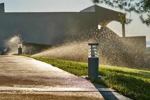 Garden automatic irrigation system. Smart lawn sprinkler system Stock Photos