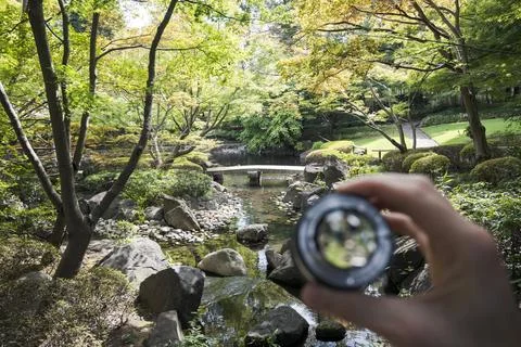 Garden bridge framed through handheld camera lens Stock Photos