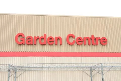 Garden centre writing caption text on beige wall building above red line in red Fotos de archivo