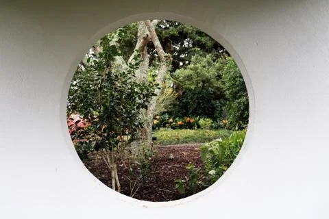 Garden from a circular window Stock Photos