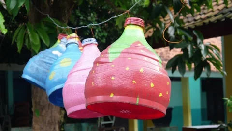 Garden decoration using used items painted to resemble fruit Stock Footage 304773418